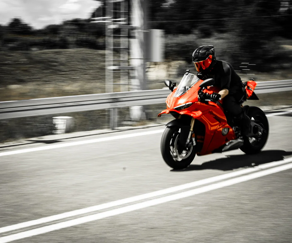 Panning action photograph of DDXMoto riding a red Ducati Panigale